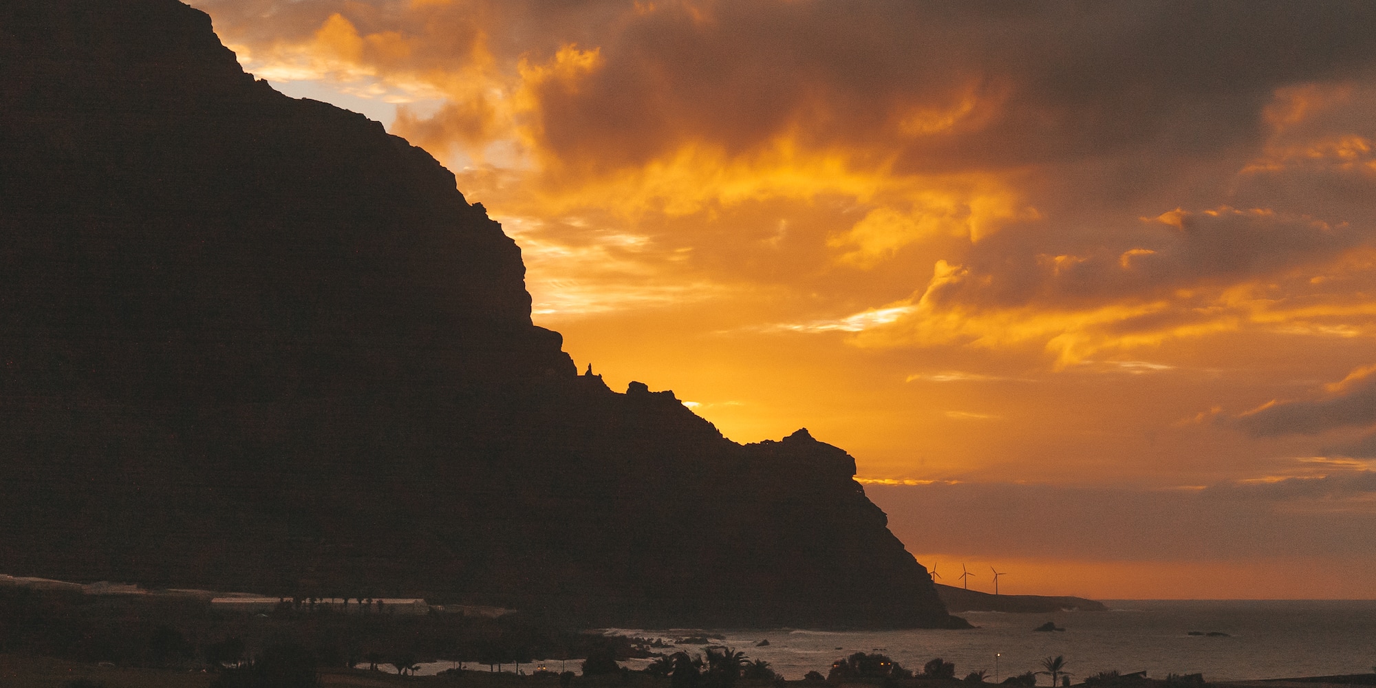 a sunset over a mountain