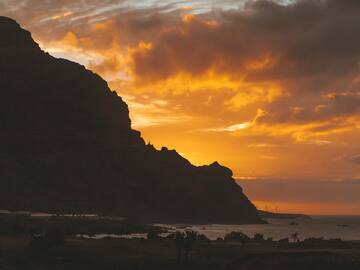 a sunset over a mountain