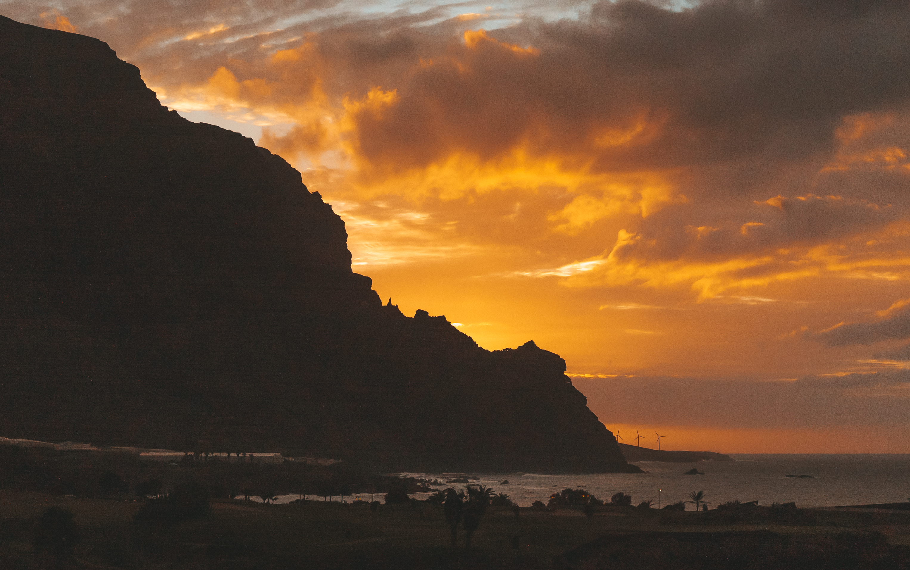 a sunset over a mountain