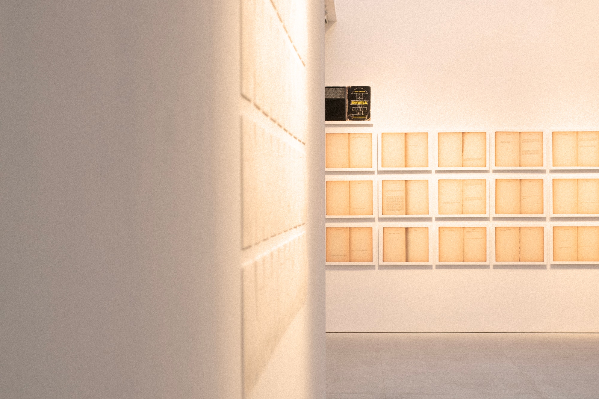 A room with white walls and one wall covered in numerous square boxes.