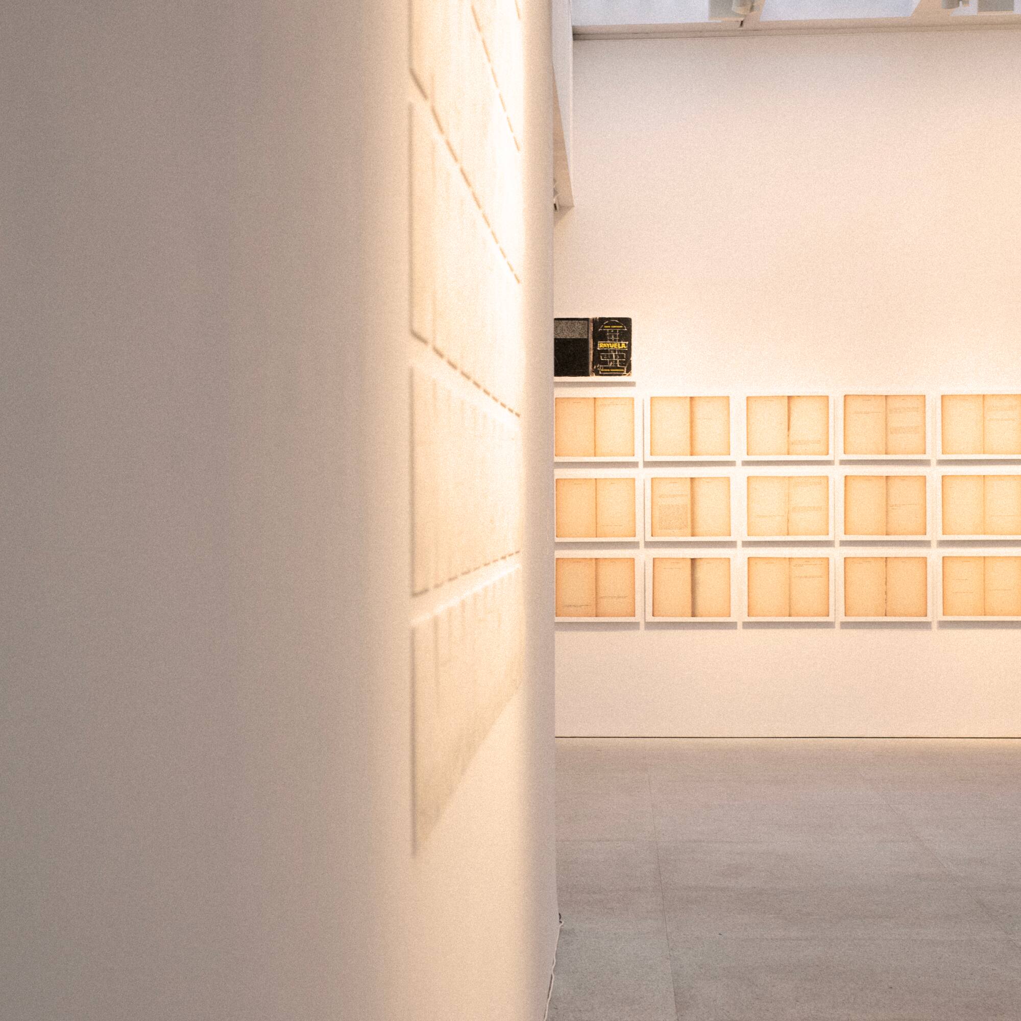 a room with white walls and a wall with many square boxes on the wall