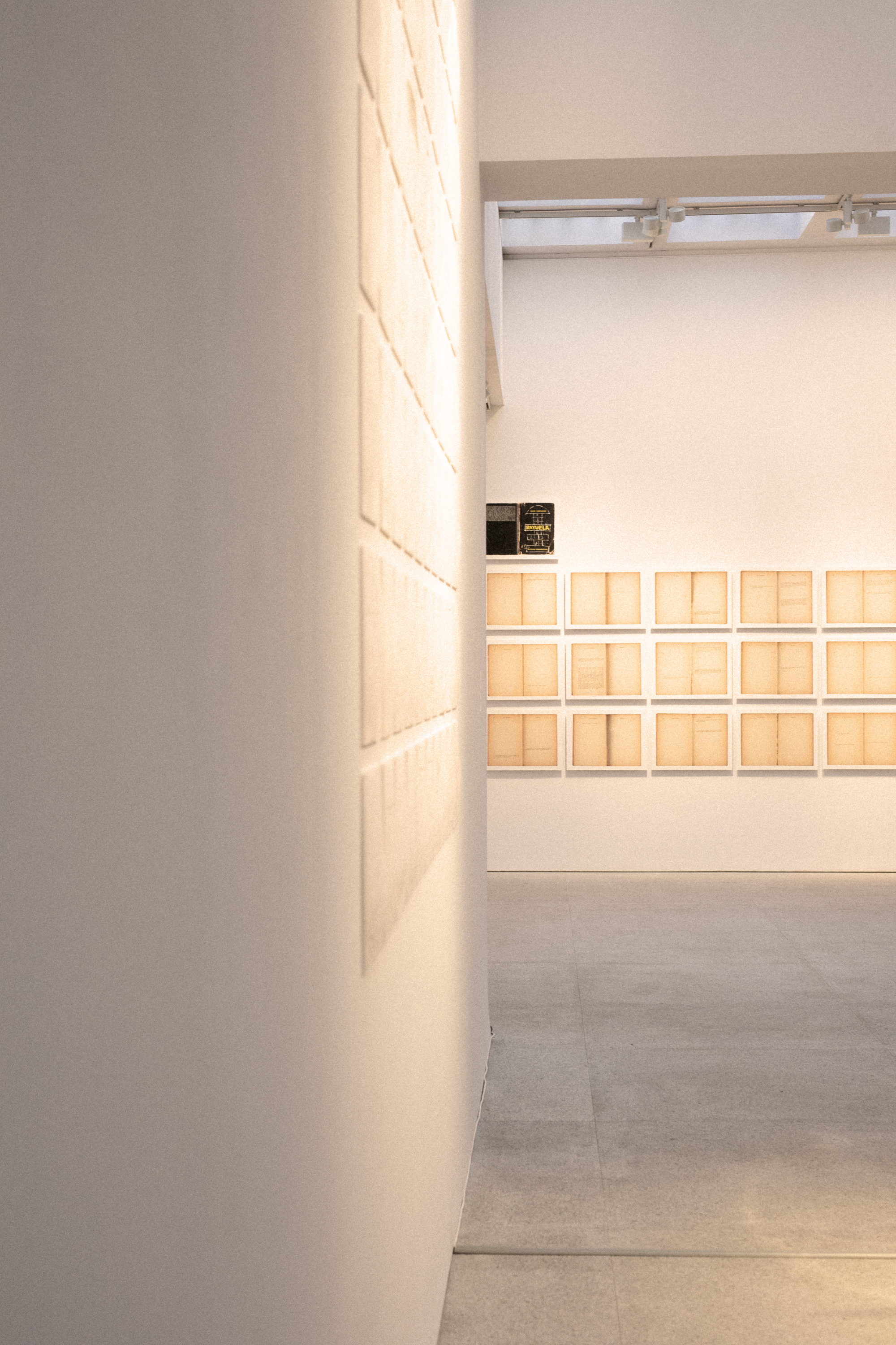 a room with white walls and a wall with many square boxes on the wall