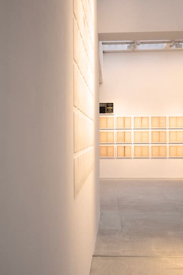a room with white walls and a wall with many square boxes on the wall
