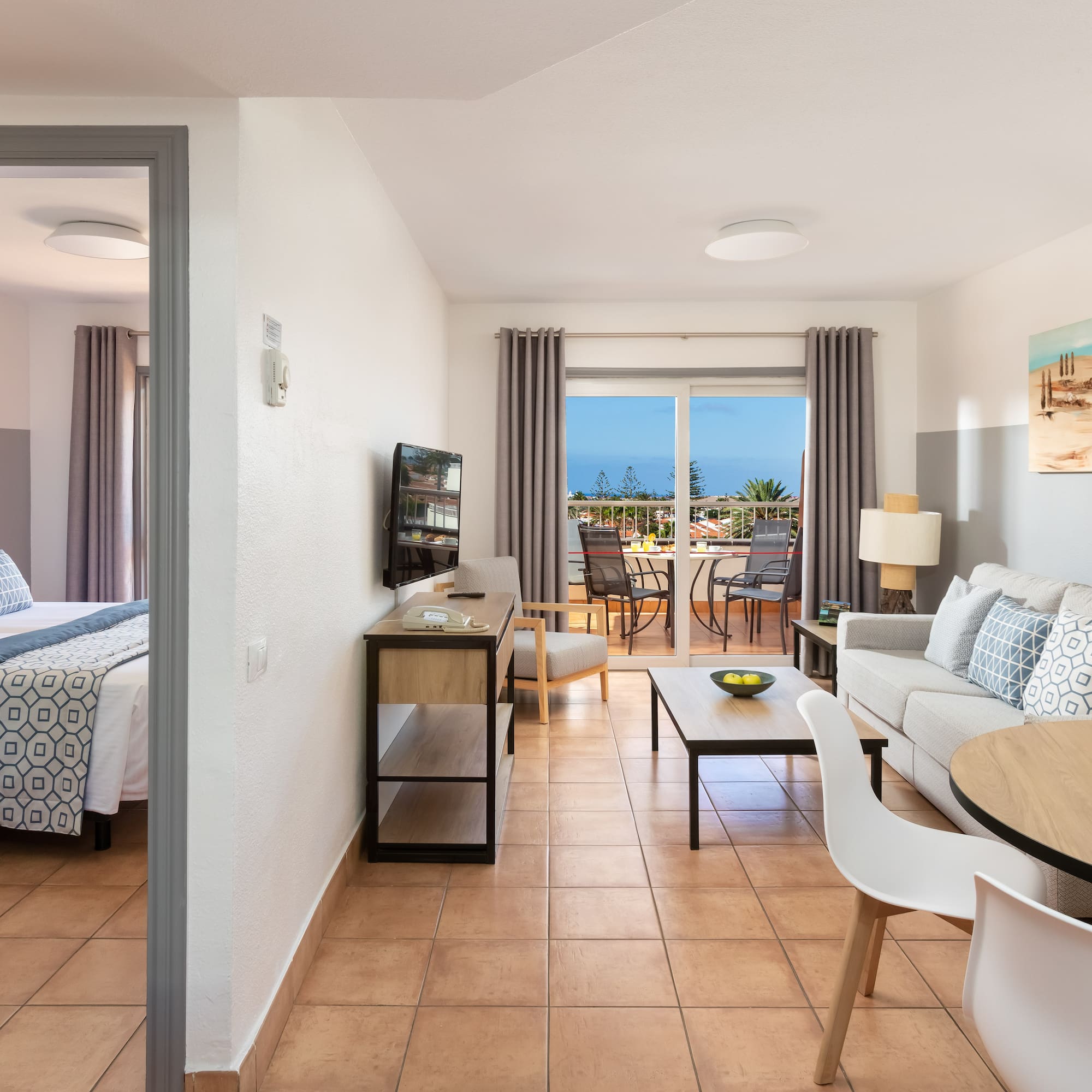 a room with a bed and a television