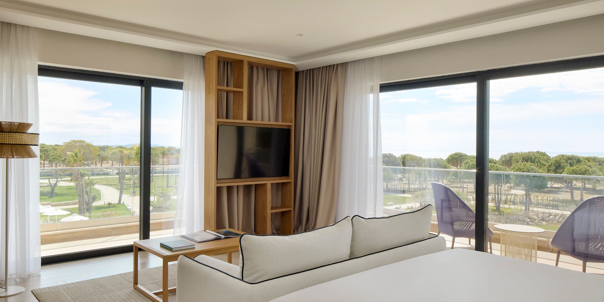 a room with a bed and a television