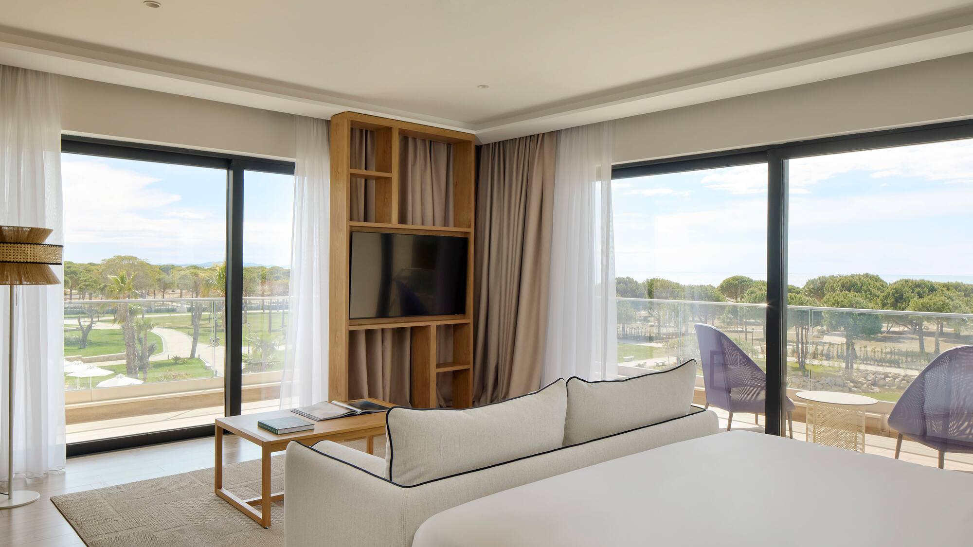 a room with a bed and a television