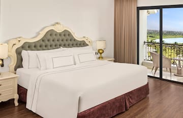 a bed with a glass door and a balcony