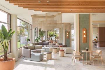 a room with a large window and a large table and chairs