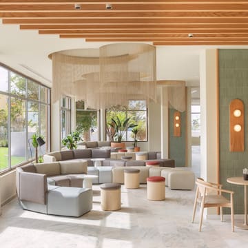 a room with a large window and a large table and chairs