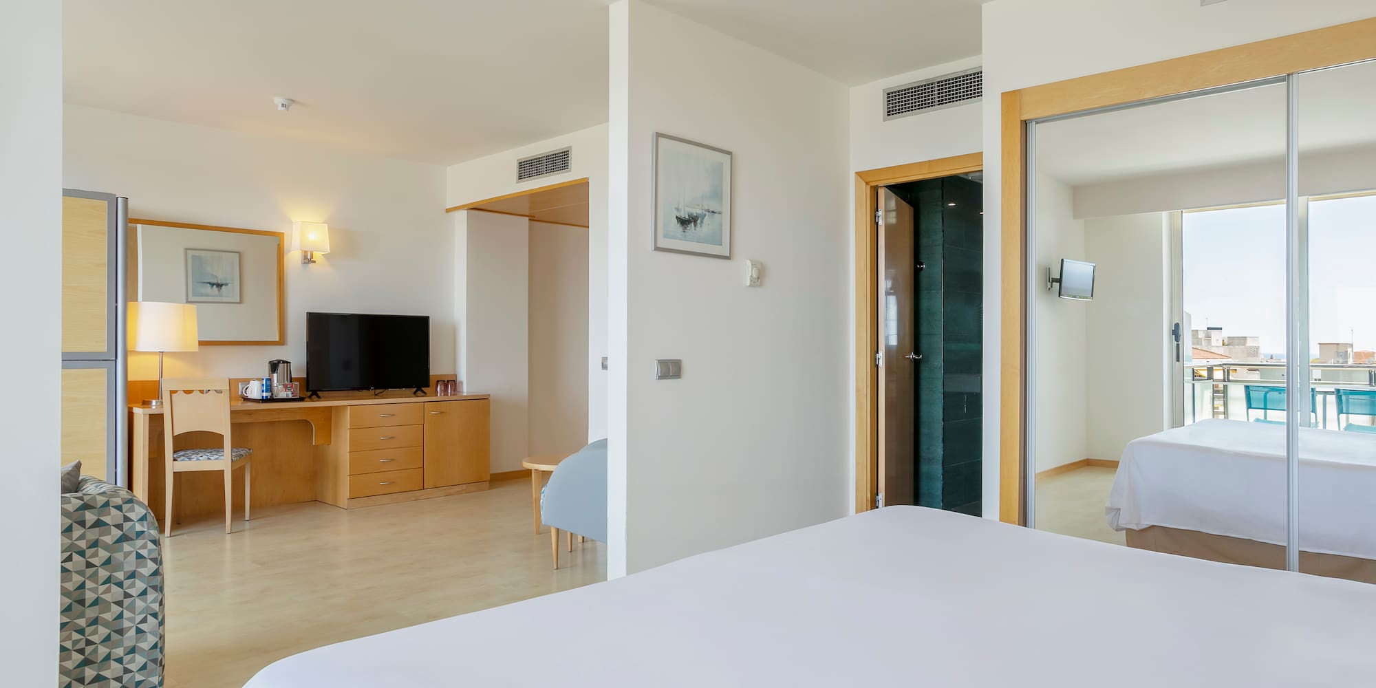 a bedroom with a bed and a desk