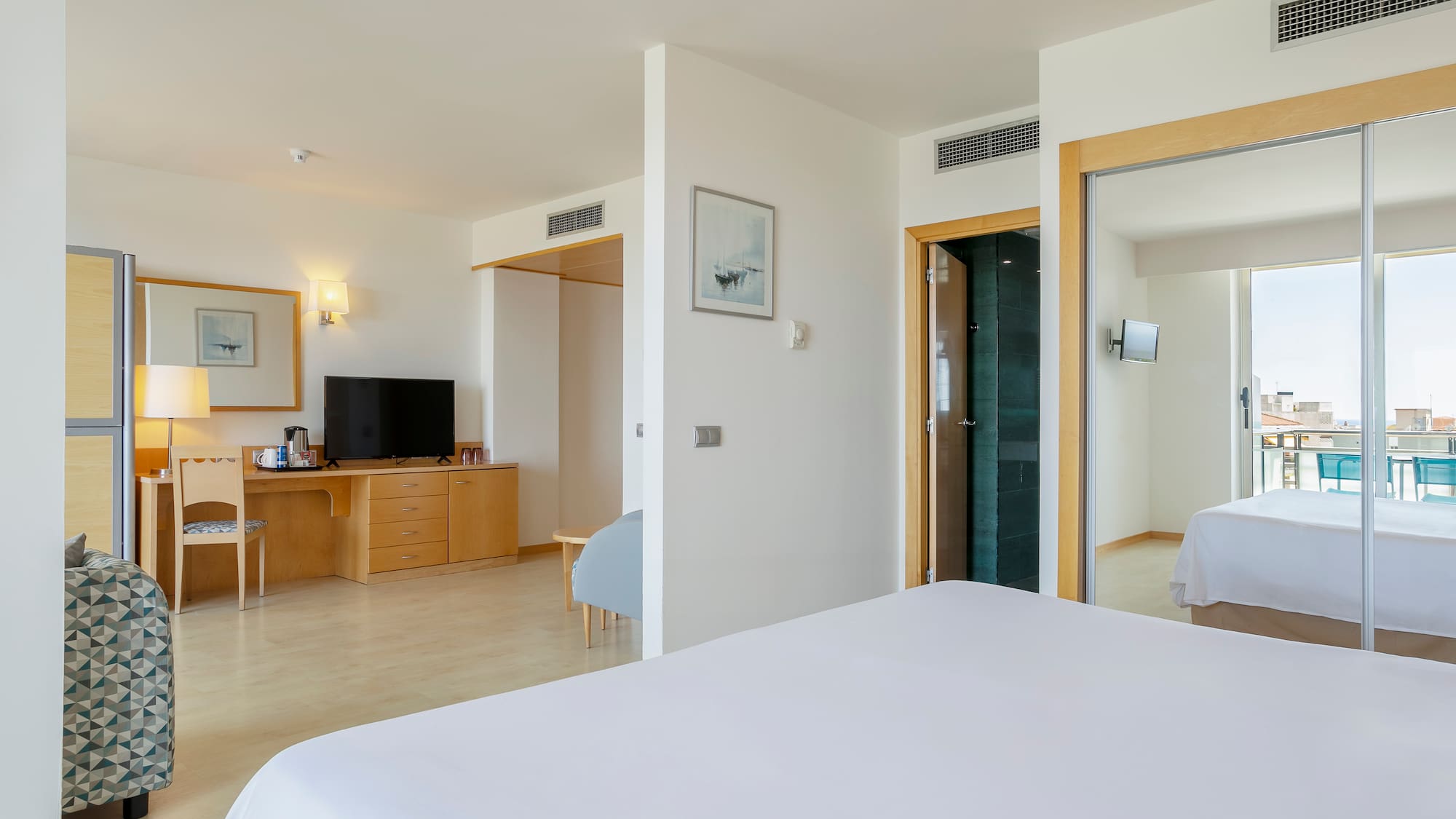 a bedroom with a bed and a desk