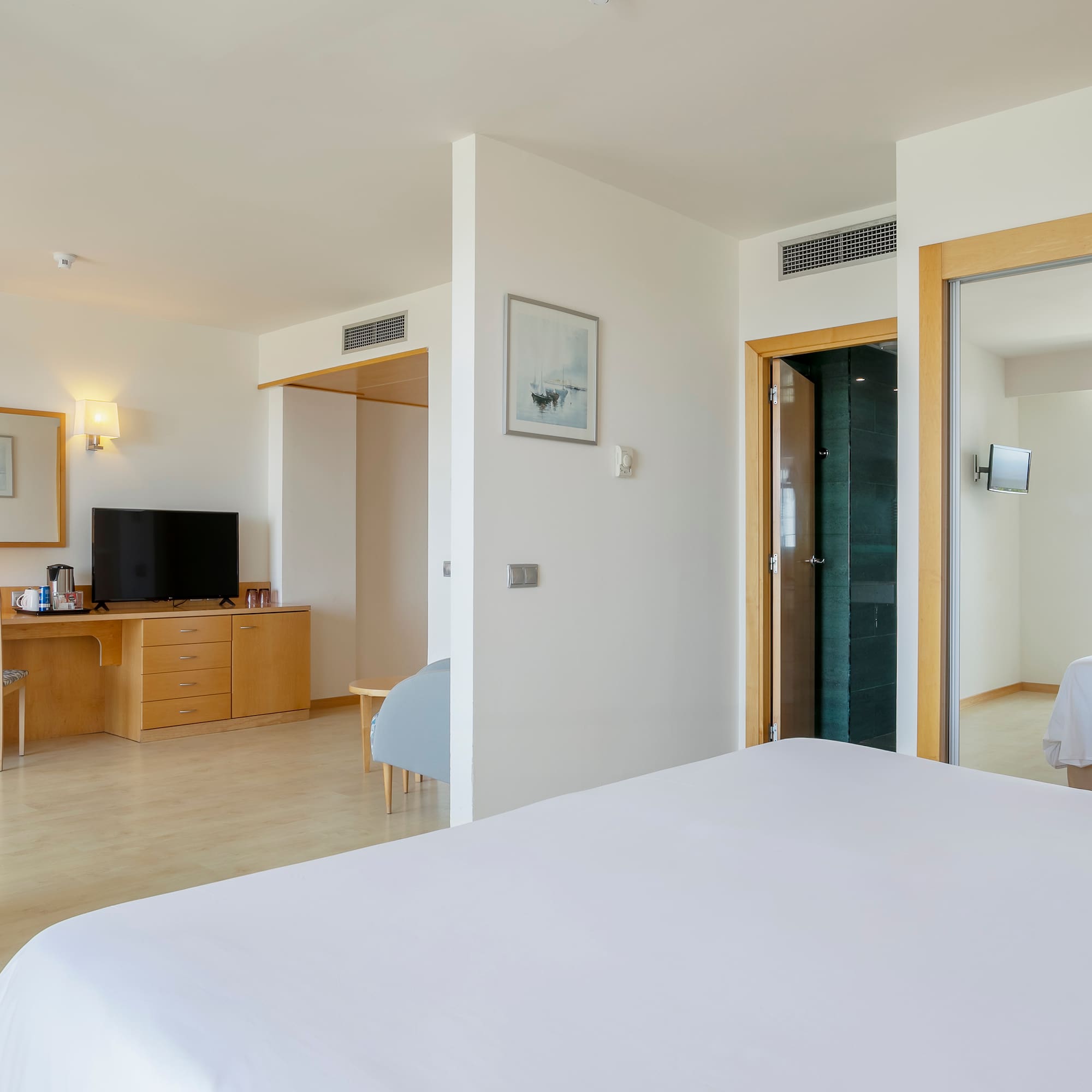 a bedroom with a bed and a desk