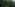 a green mountain range with trees