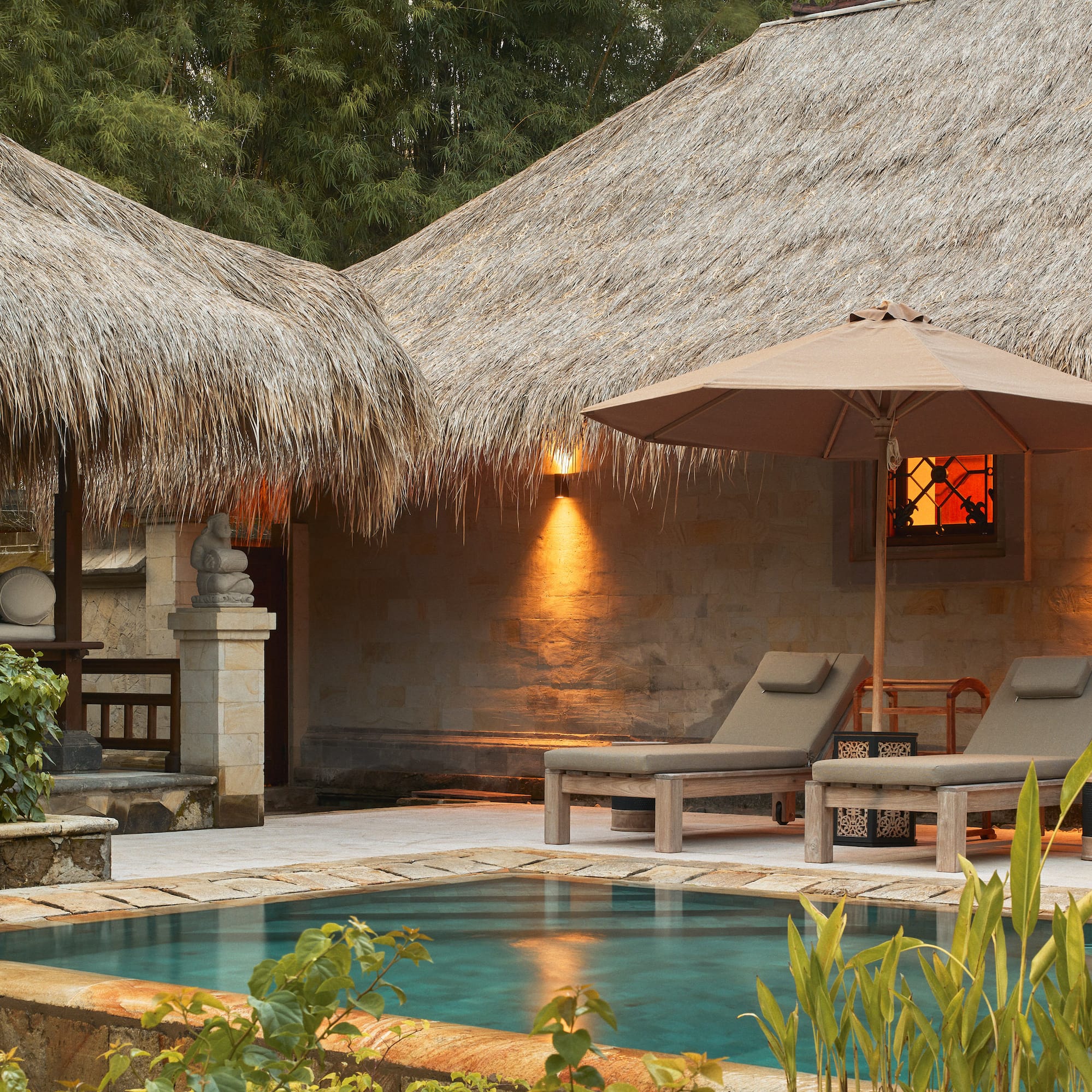 a pool and lounge chairs in a resort