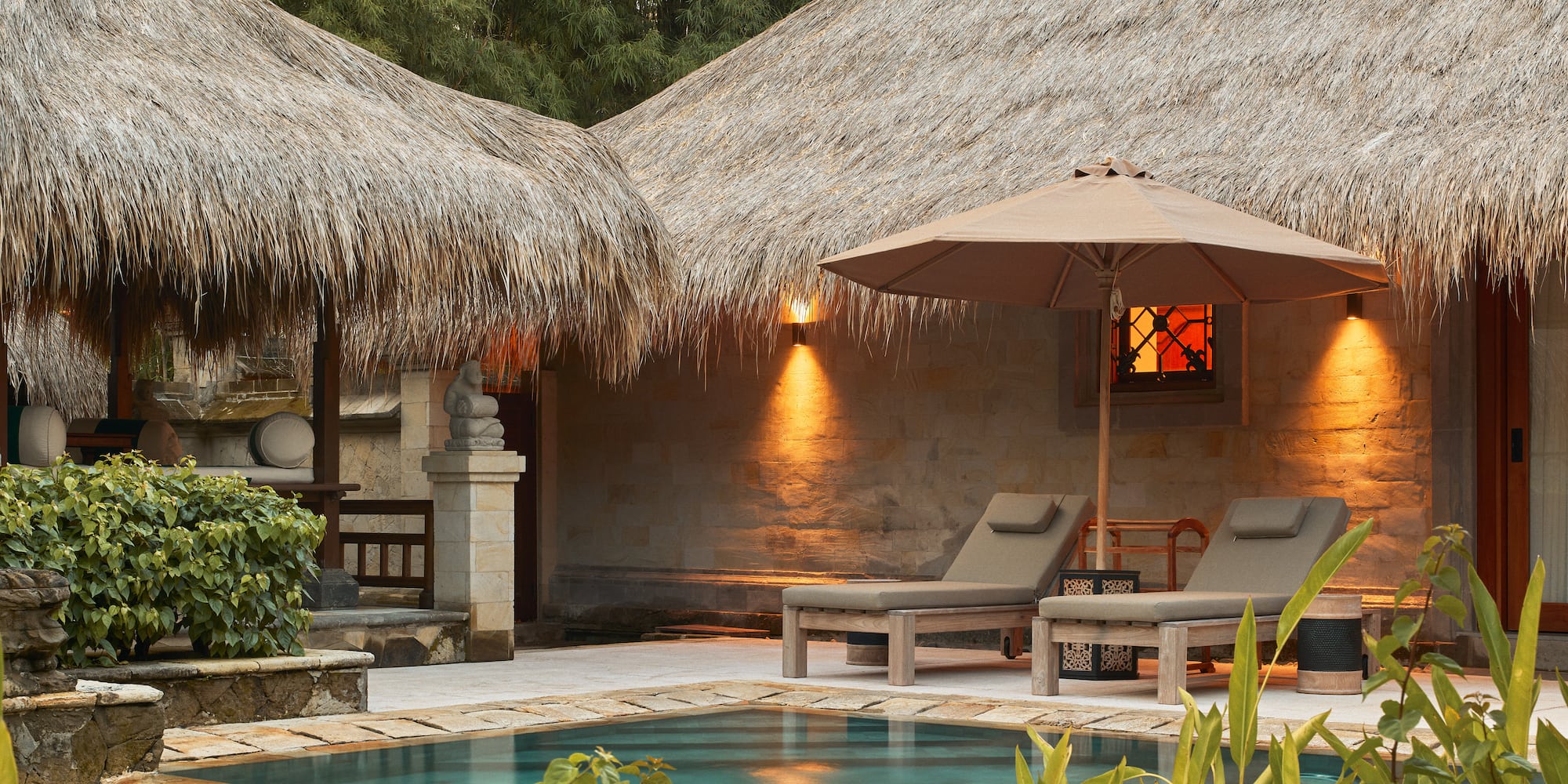a pool and lounge chairs in a resort