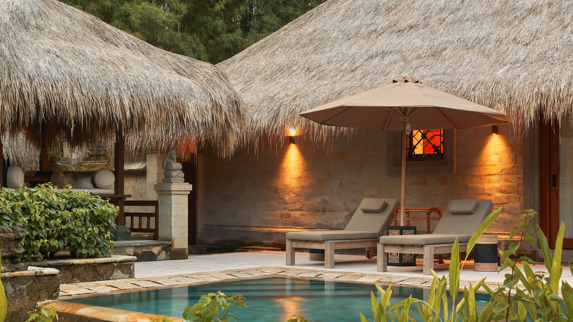 a pool and lounge chairs in a resort