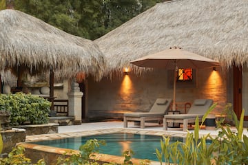 a pool and lounge chairs in a resort