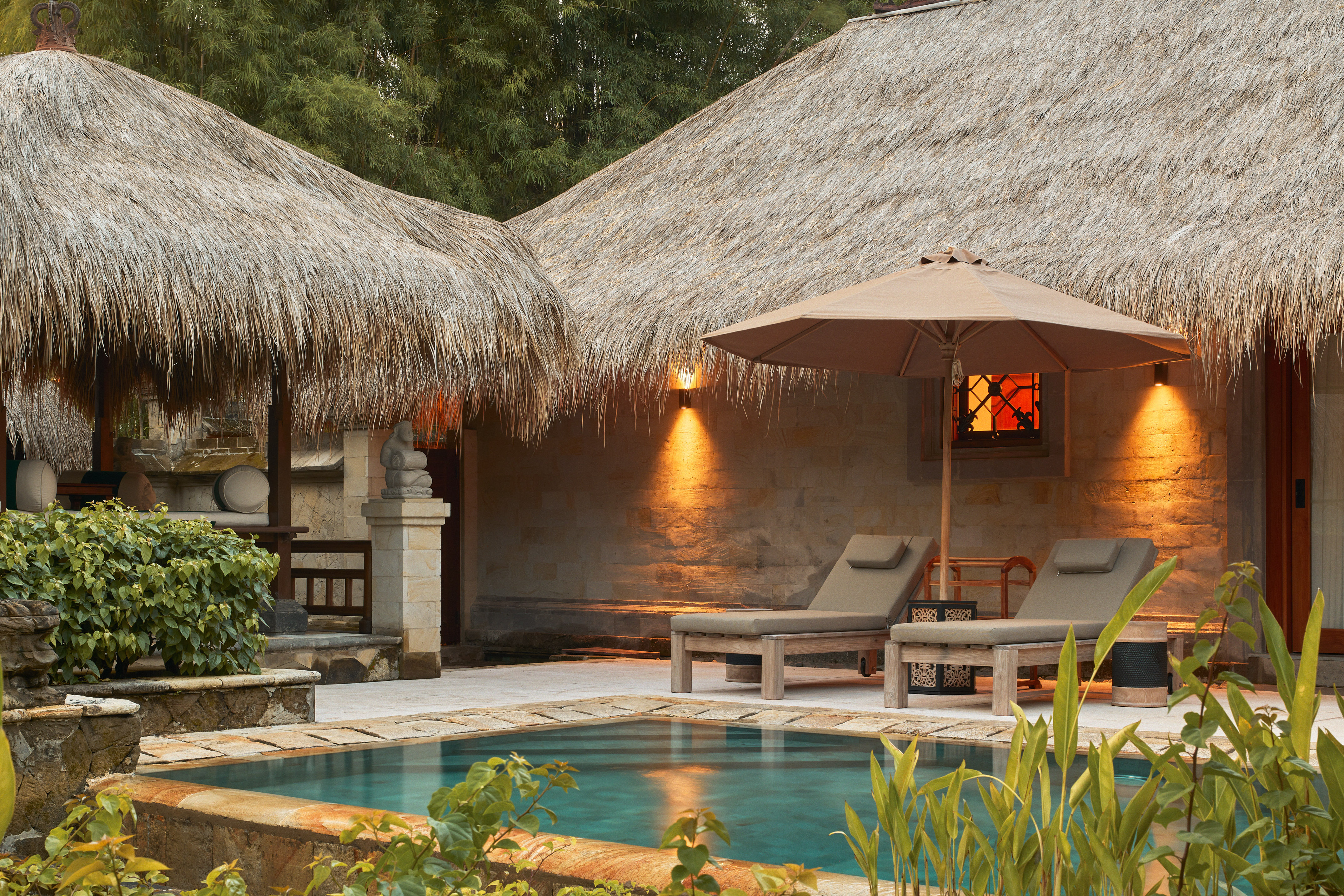 a pool and lounge chairs in a resort