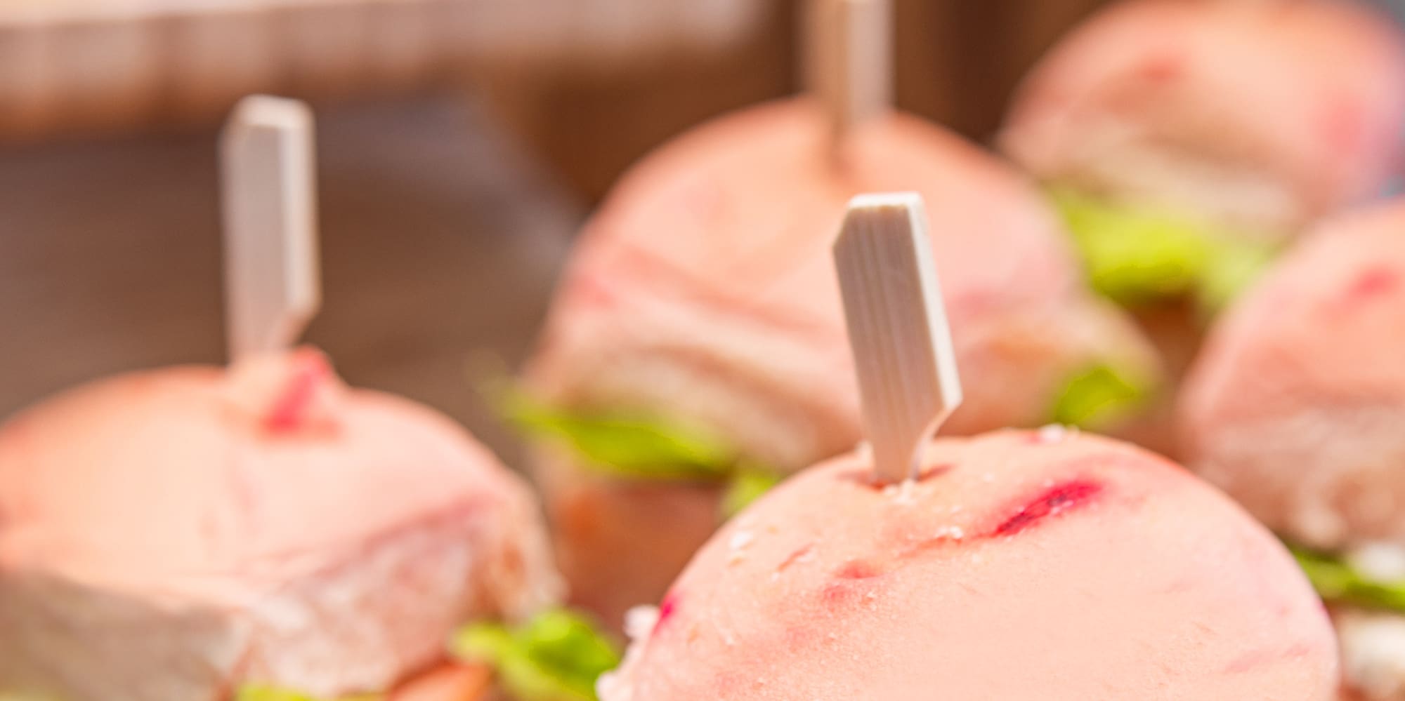 a group of sandwiches with meat and vegetables