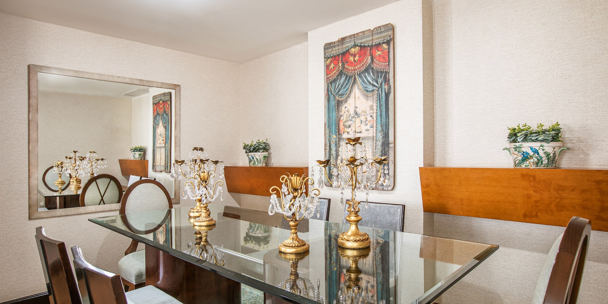 a dining room with a glass table and chairs