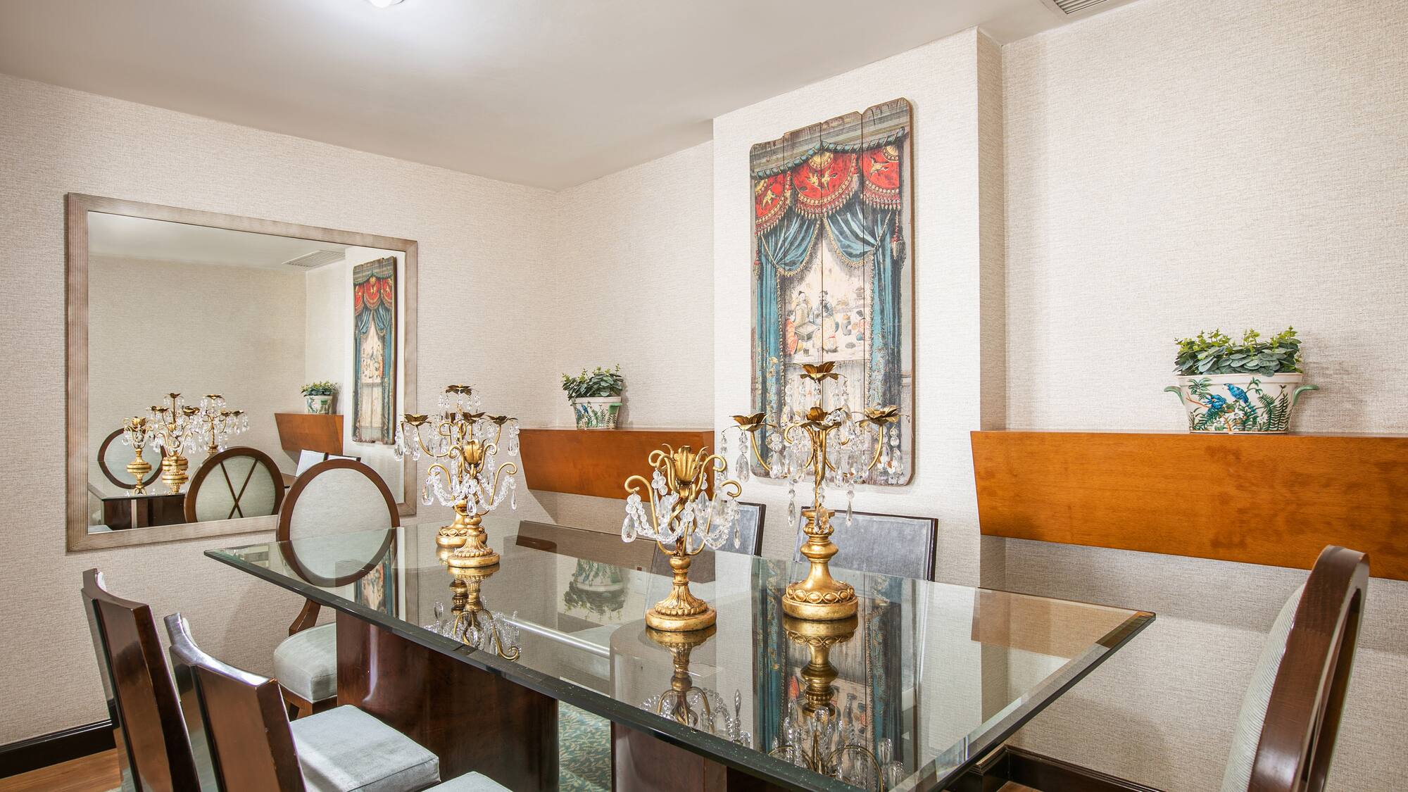 a dining room with a glass table and chairs