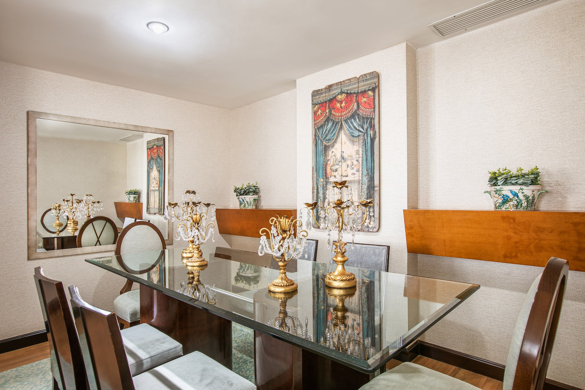 a dining room with a glass table and chairs