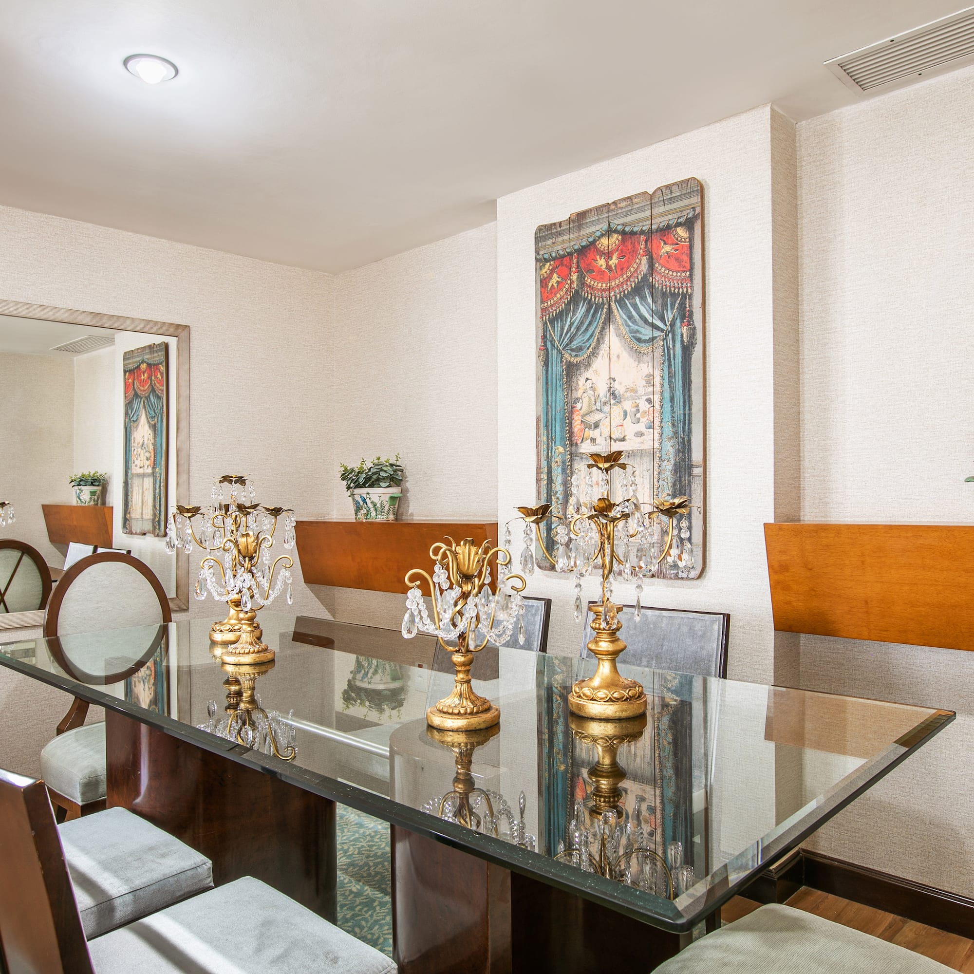 a dining room with a glass table and chairs