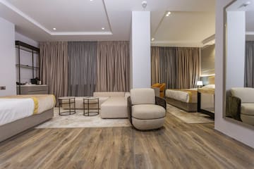 a room with a couch and beds