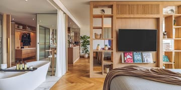 a bedroom with a tv and a bathtub
