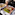 a person's hand reaching for a plate of food