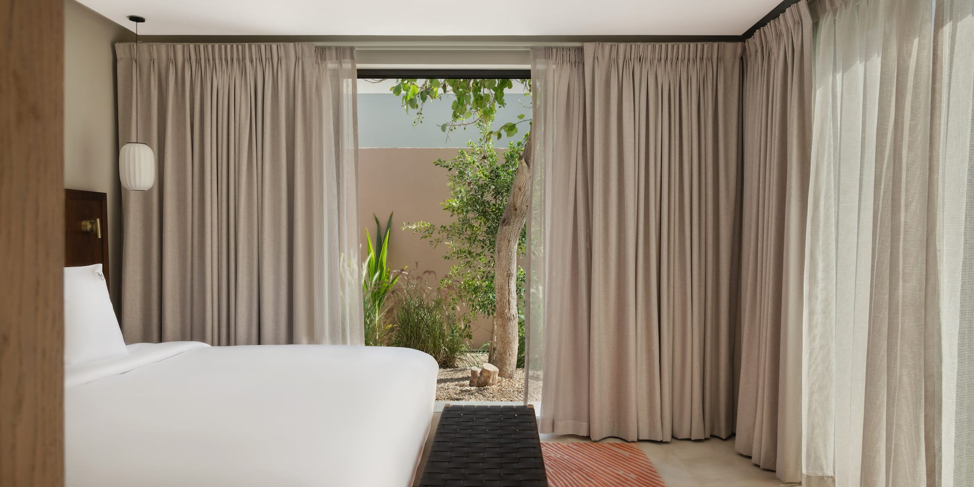 a bed in a room with curtains