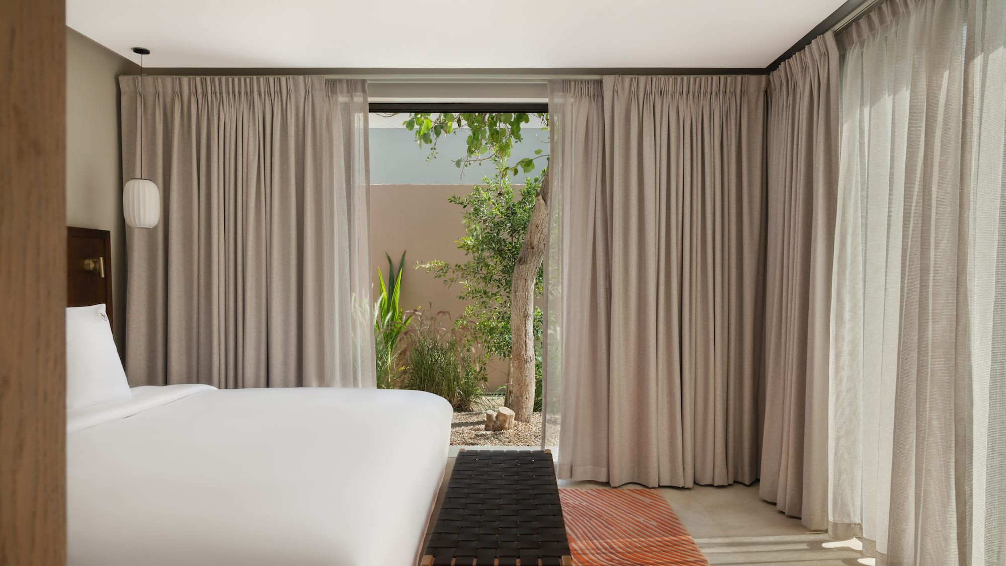 a bed in a room with curtains