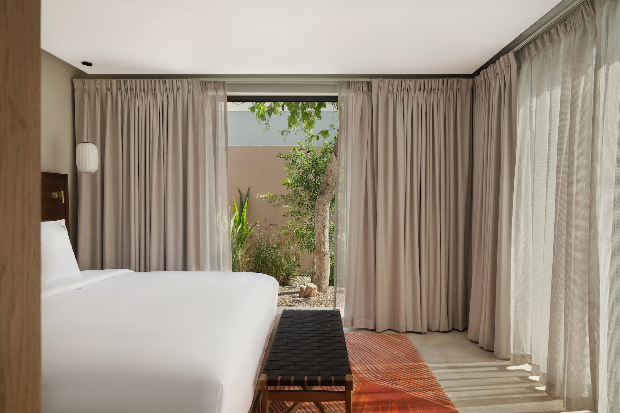 a bed in a room with curtains