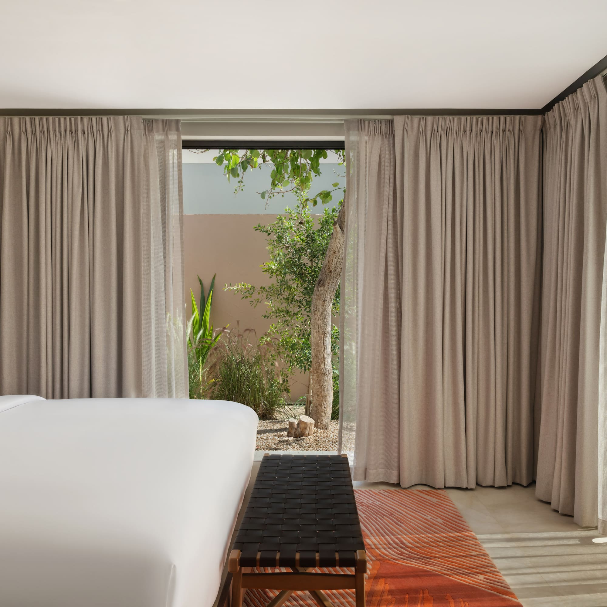 a bed in a room with curtains