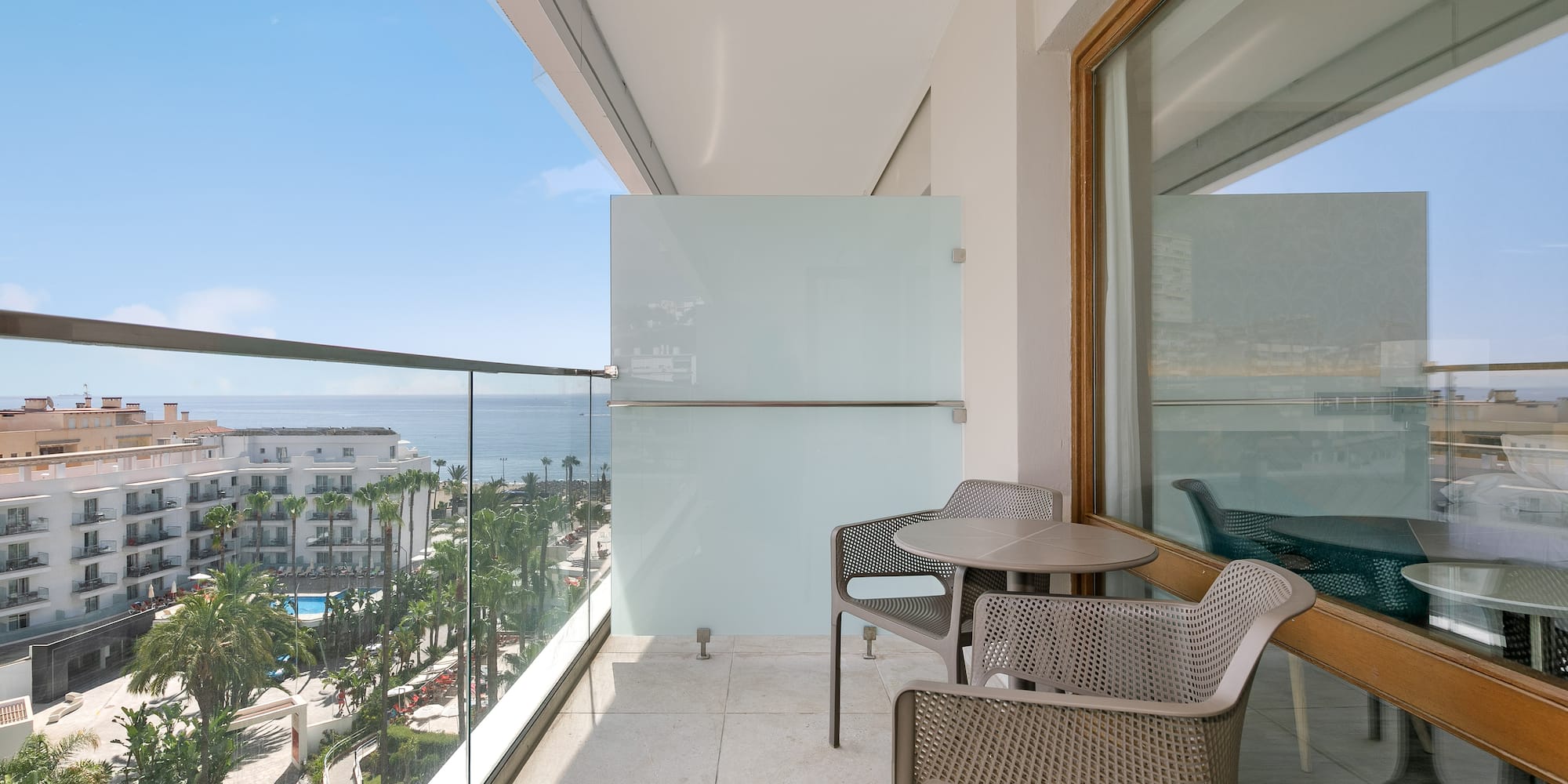 a balcony with chairs and table