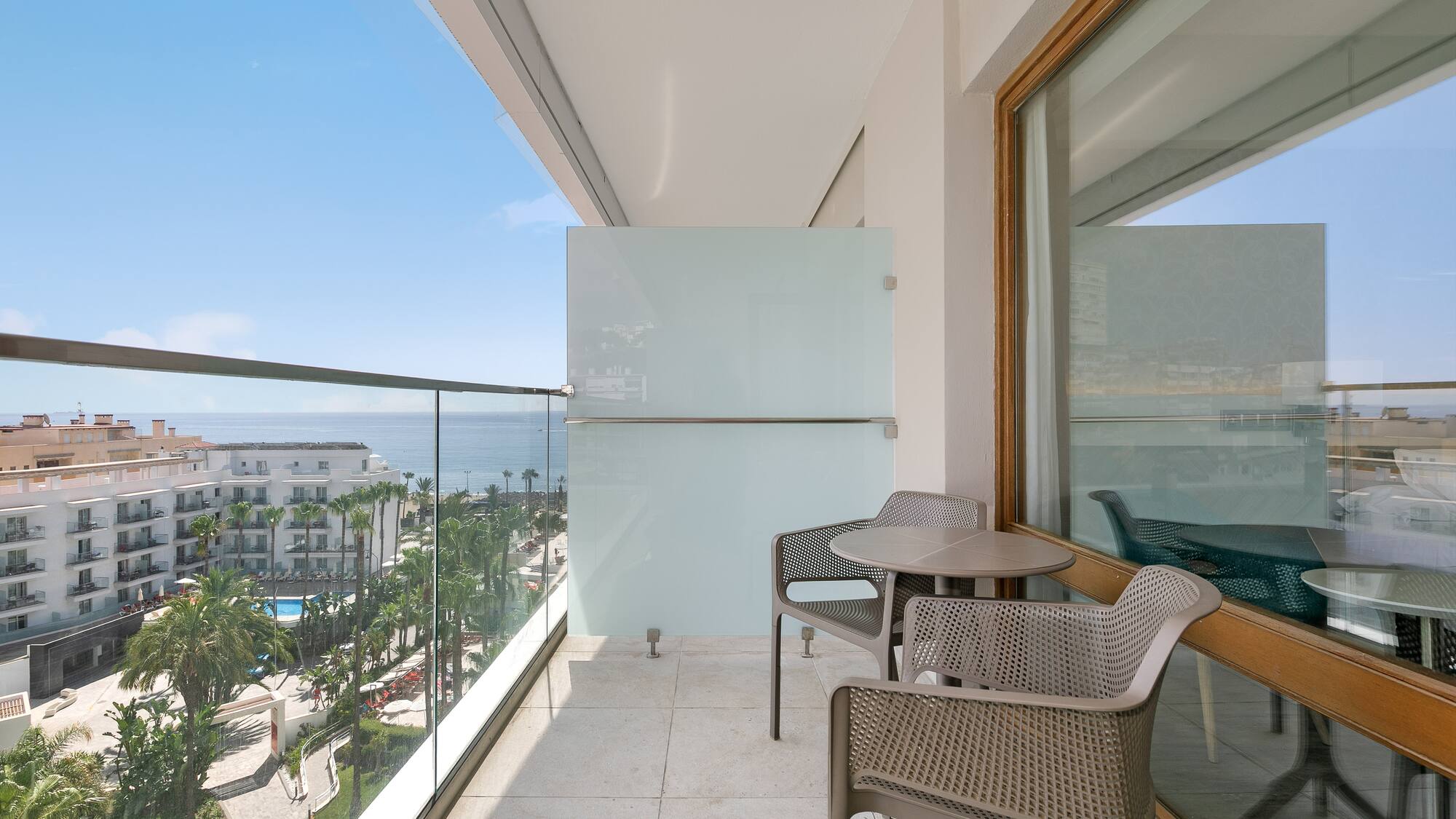 a balcony with chairs and table