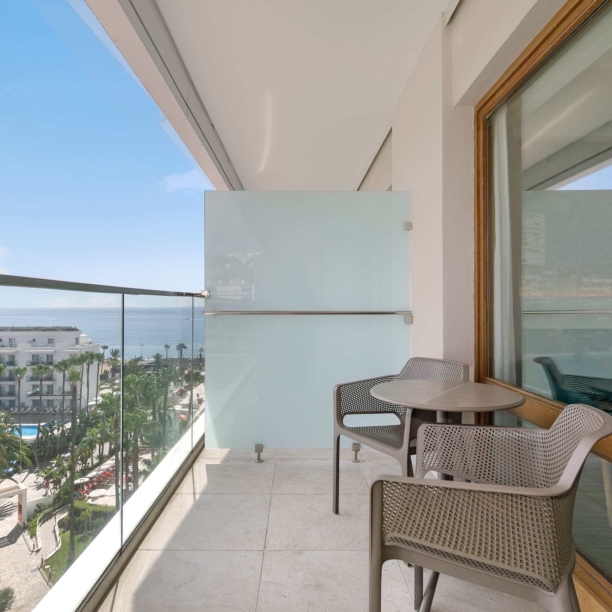 a balcony with chairs and table
