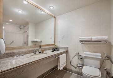 a bathroom with a marble countertop and a large mirror