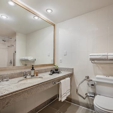 a bathroom with a marble countertop and a large mirror
