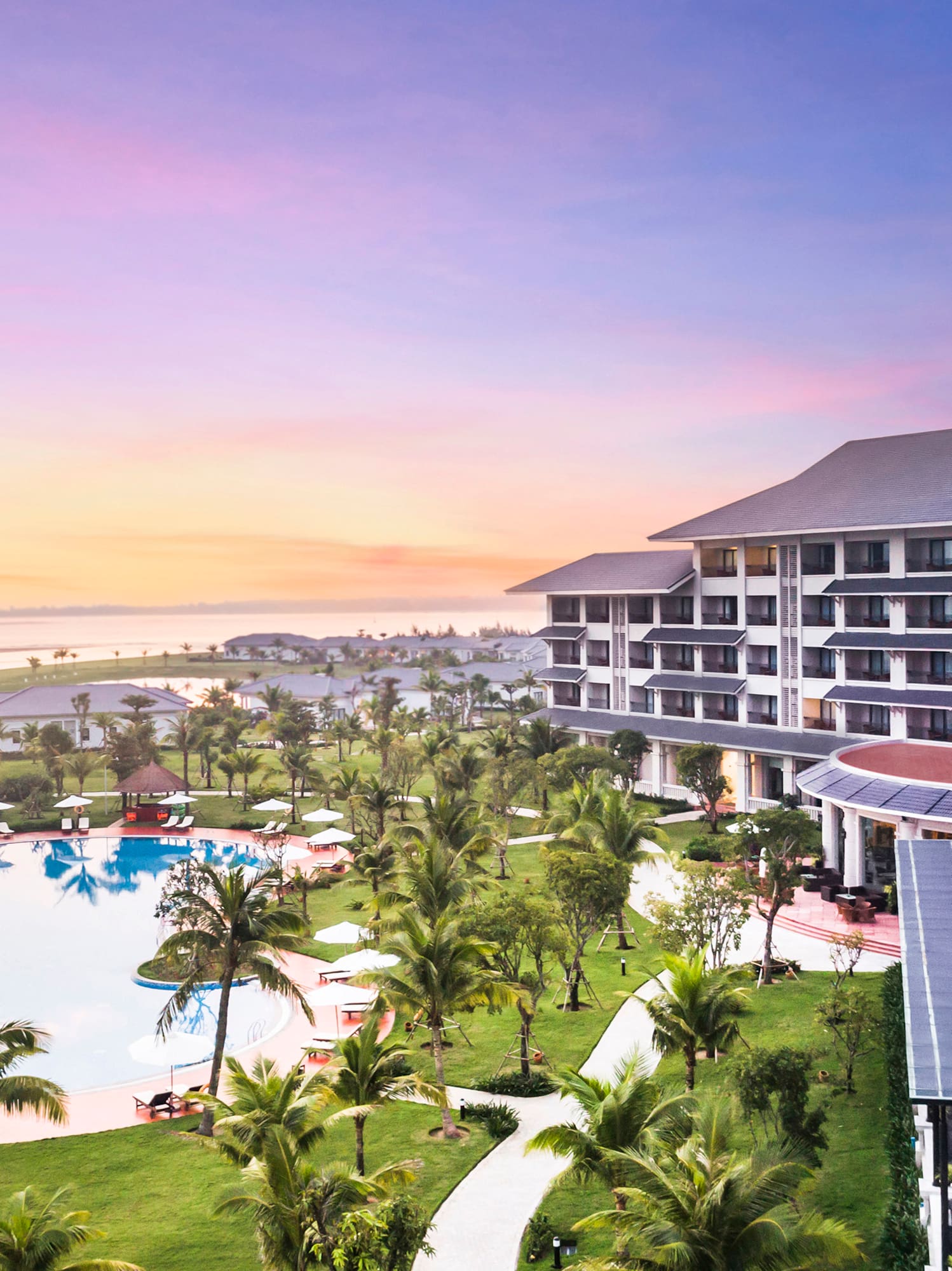 a hotel with a pool and palm trees