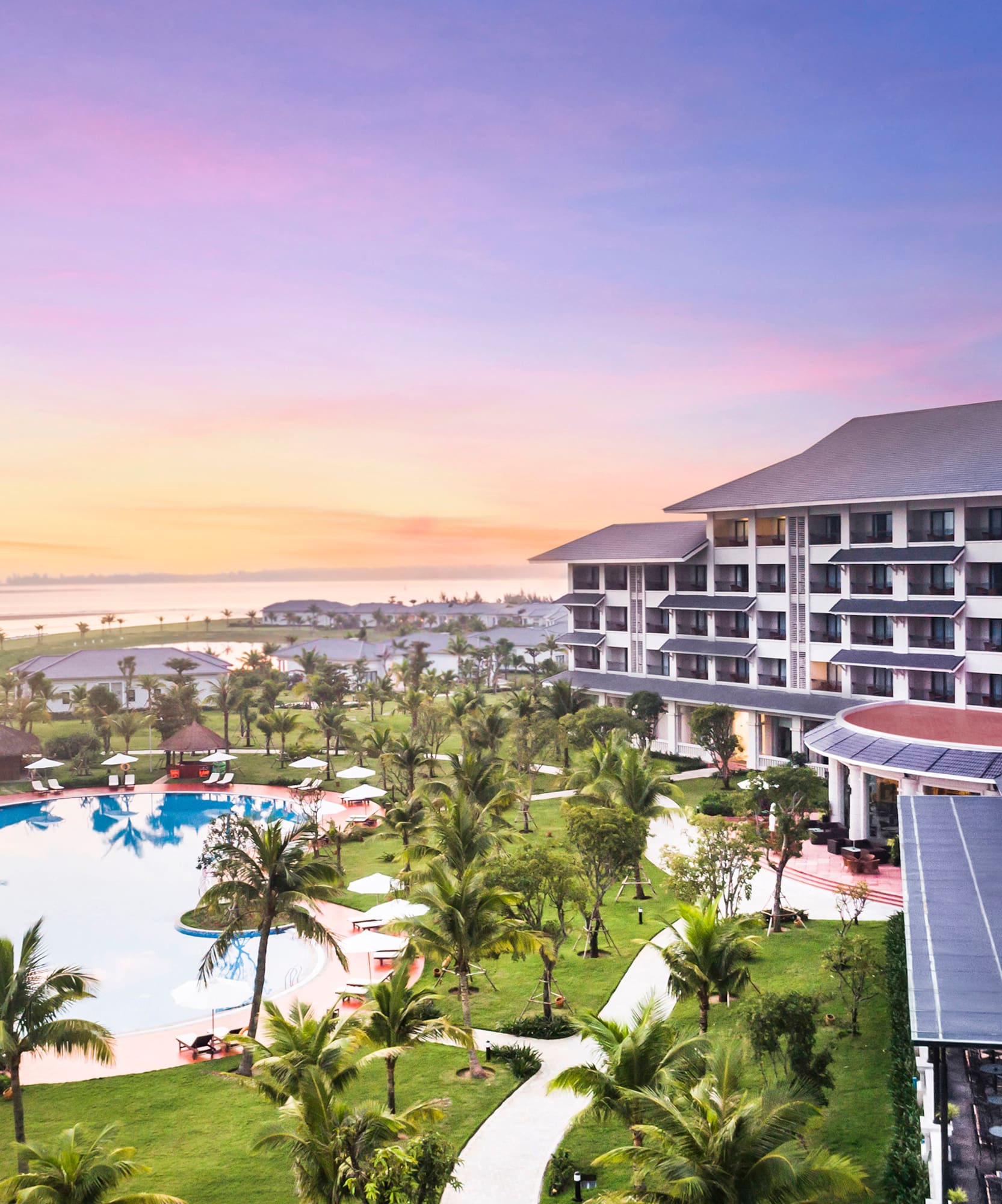 a hotel with a pool and palm trees