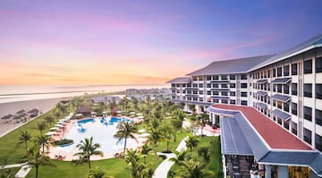 a hotel with a pool and palm trees