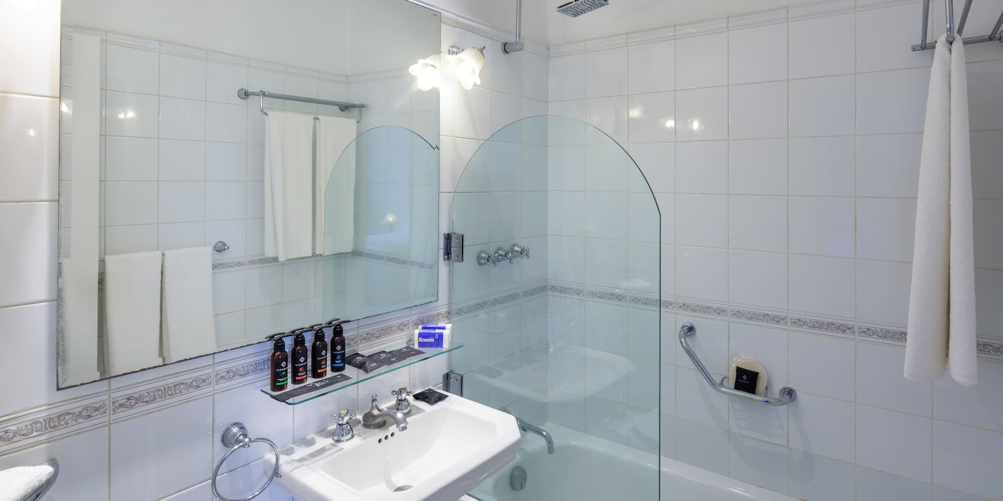 a bathroom with a glass shower and tub