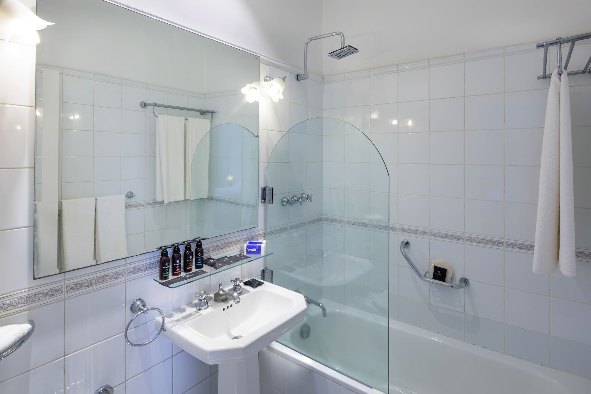 a bathroom with a glass shower and tub