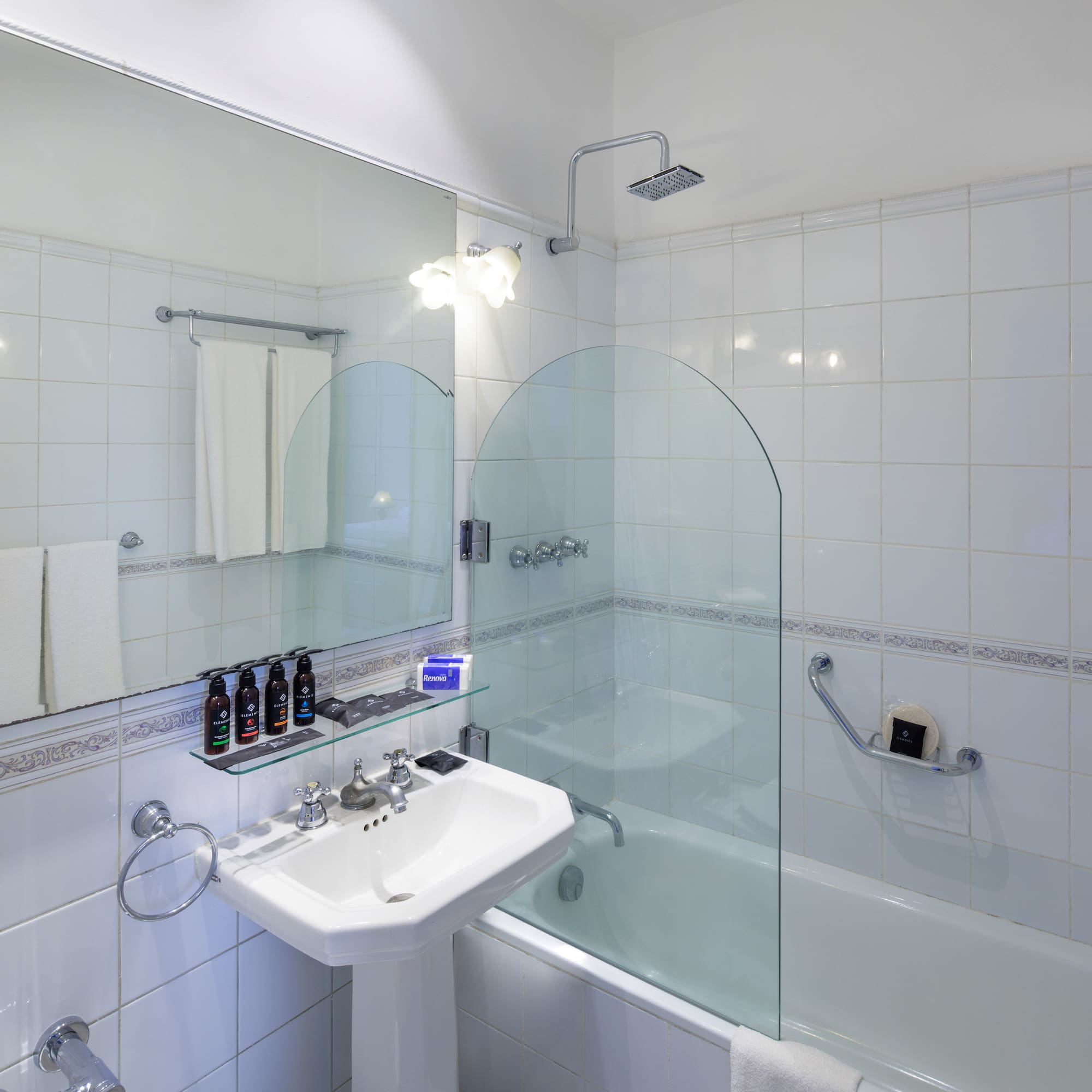 a bathroom with a glass shower and tub