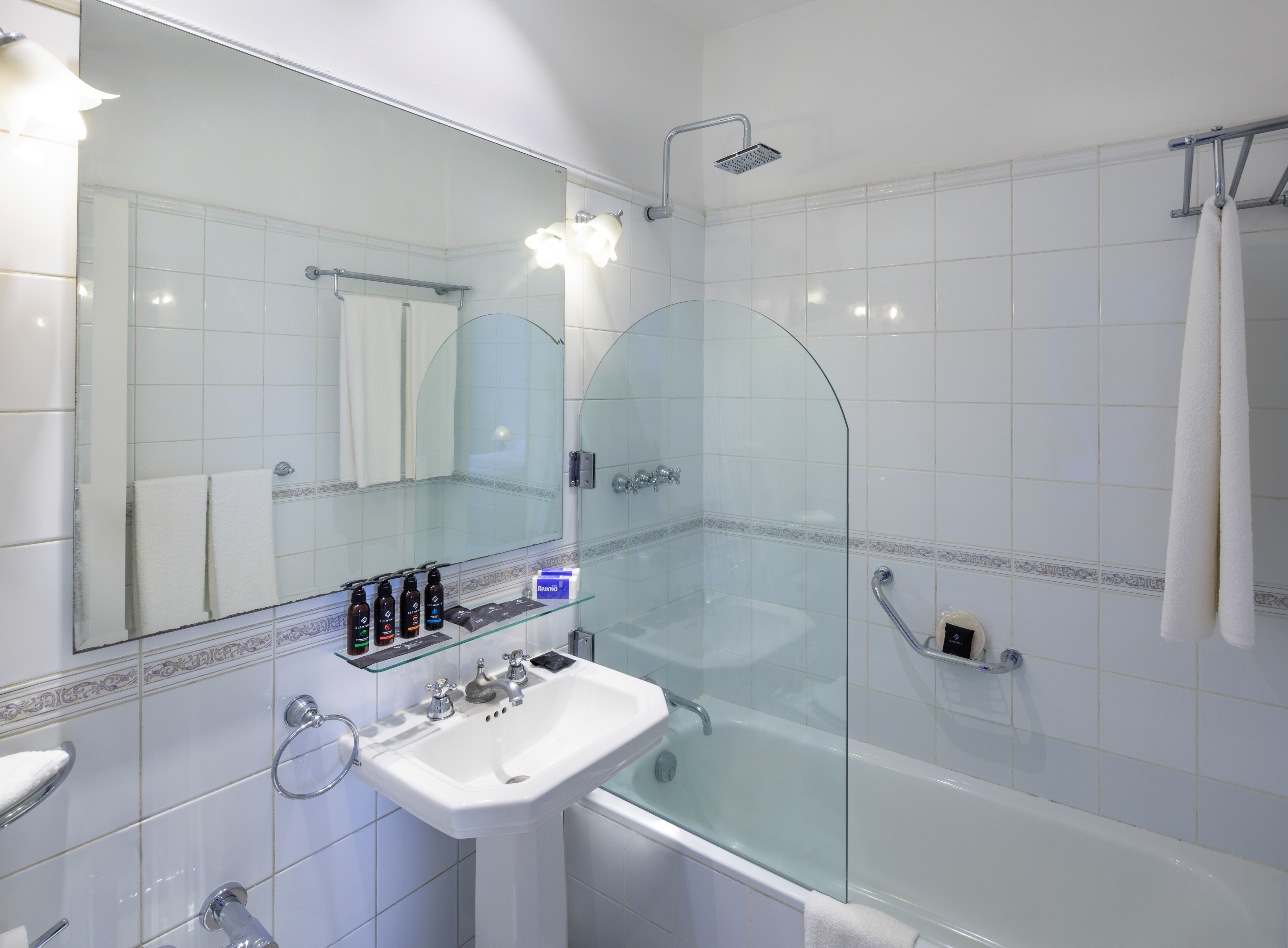 a bathroom with a glass shower and tub