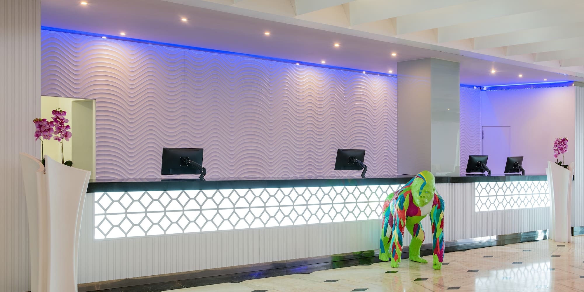 a person in a garment standing in front of a reception desk