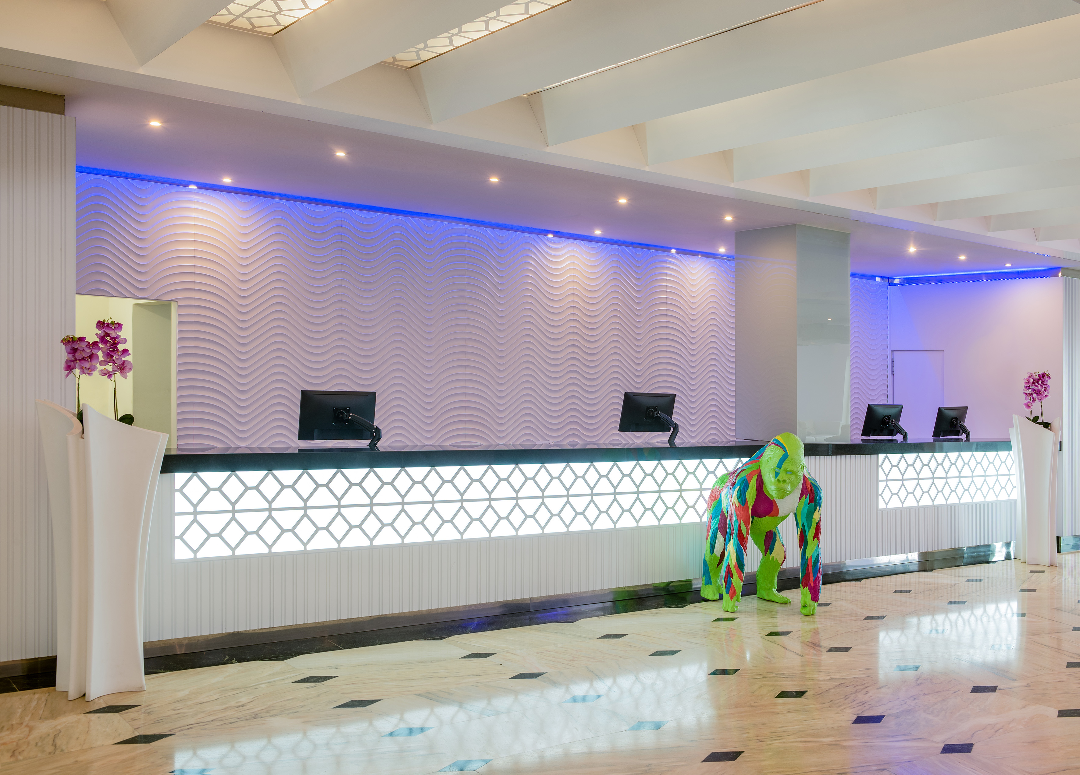 a person in a garment standing in front of a reception desk