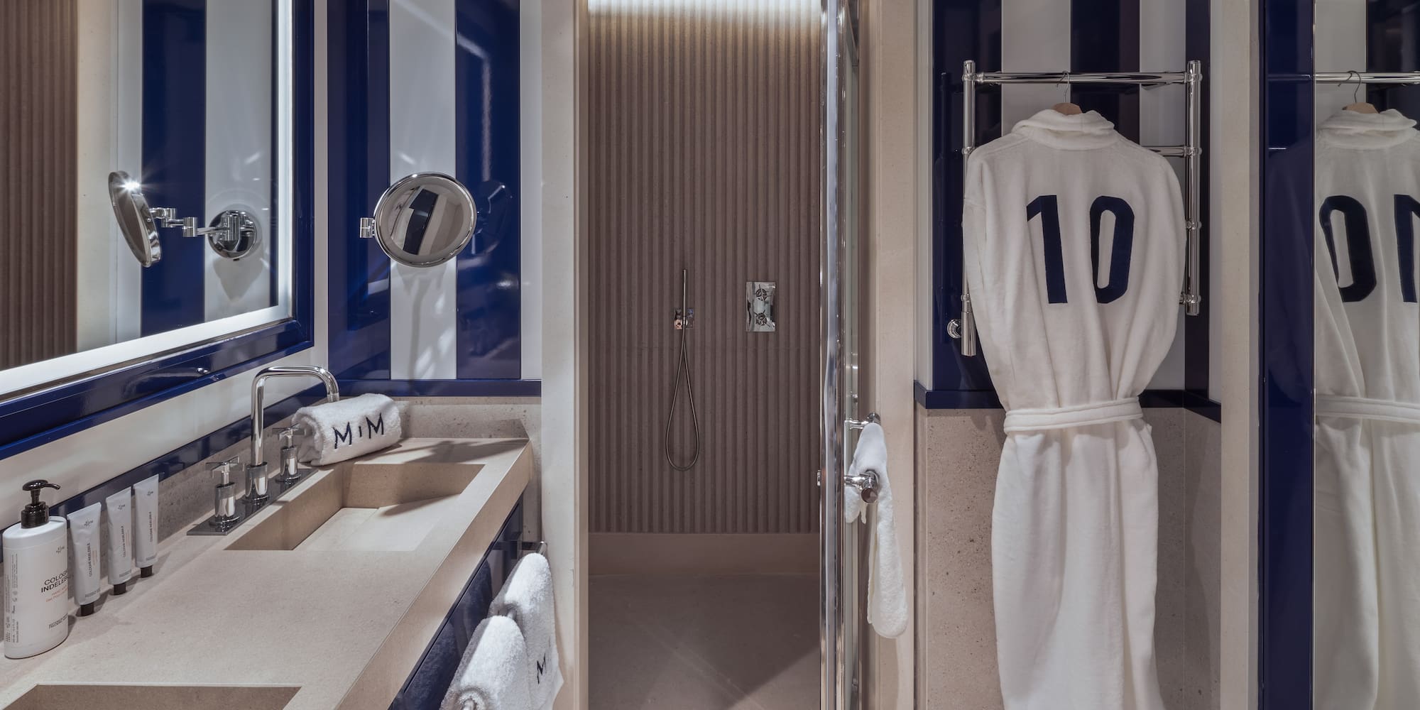 a bathroom with a towel on a swinger and a shower