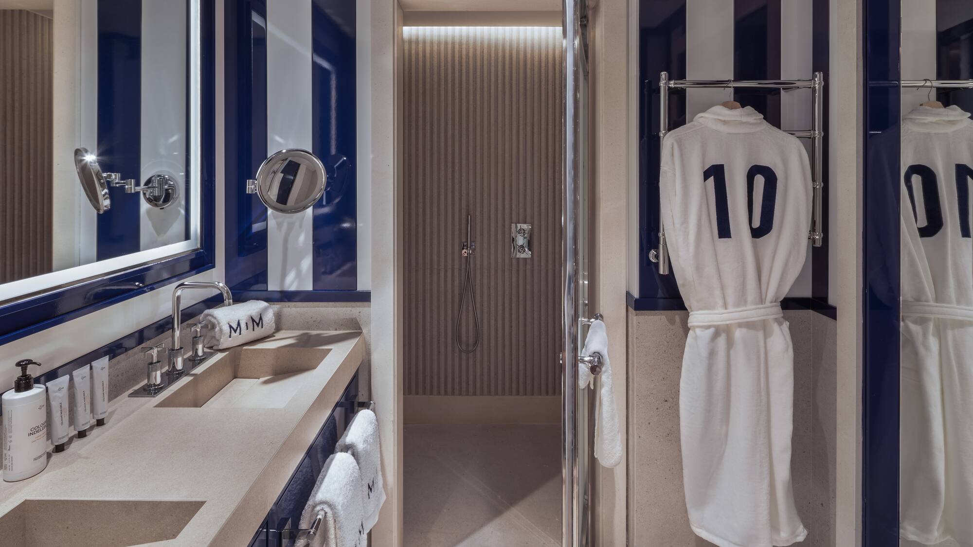 a bathroom with a towel on a swinger and a shower